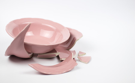 Broken and whole plate on a light background.