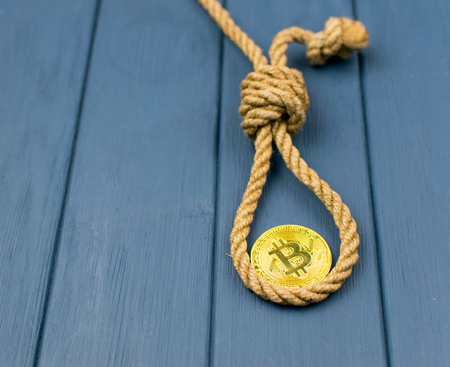 End of bitcoin. Coin bitcoin in the loop of the gallows.の写真素材