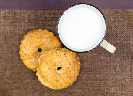 A cup of milk and cookies.の写真素材