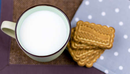 A cup of milk and cookies.の写真素材