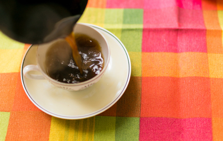 Pouring coffee into the cup.の写真素材