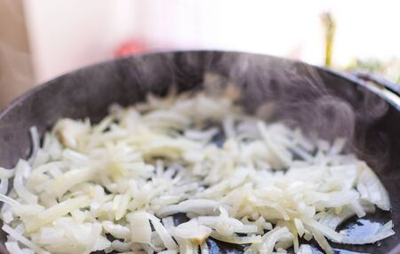 Fry the chopped onions in a frying pan.の写真素材