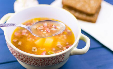 Soup of saltwort. Soup from different types of sausages, olives, potatoes, tomato paste.の写真素材