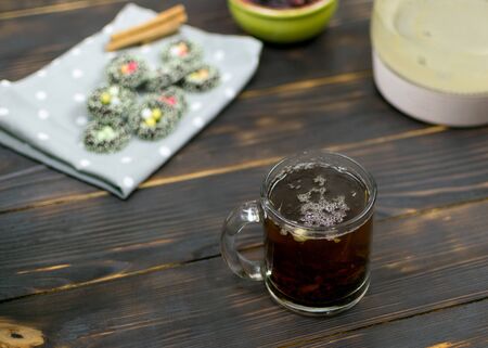 A cup with herbal tea and cookies on a dark background.の写真素材