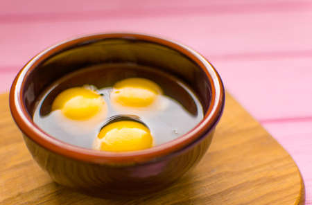 Raw chicken eggs in a plate .の写真素材