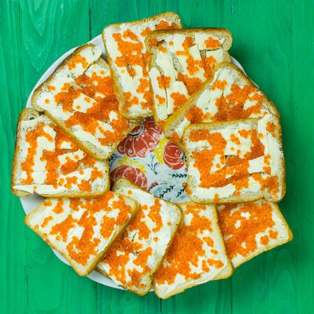 Sandwiches with red caviar on a light green background.の写真素材