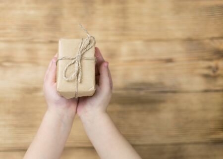 The hands of the child hold a gift.の写真素材