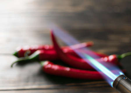 Spicy red hot chilli pepper with fire.