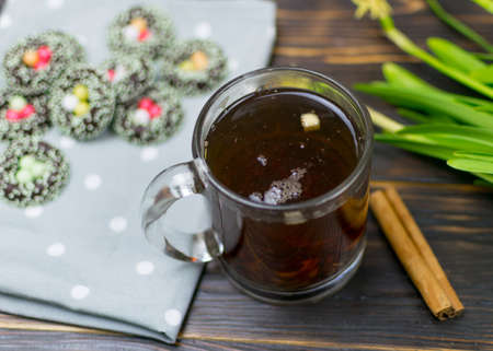 A cup with herbal tea and cookies on a dark background.の写真素材