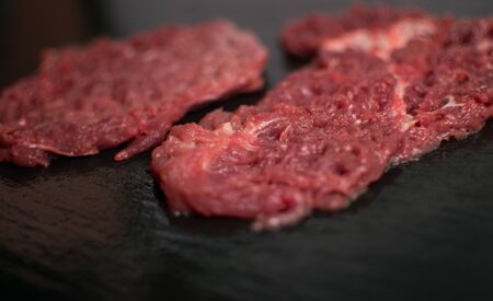 Raw pork chop on a dark background.の写真素材