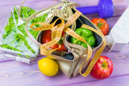 Female weight loss. Diet. A set of vegetables in a woman's handbag. A funny concept is the decision of a woman to lose weight.の写真素材