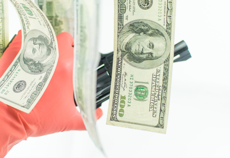 Pistol and money on a white background. The concept of crime is because of money.
