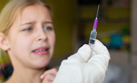Fear of injections, the child with the nurse.The girl in the treatment room.The girl is crying.