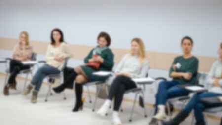 A group of people at a seminar, conference in the blur effect.の写真素材
