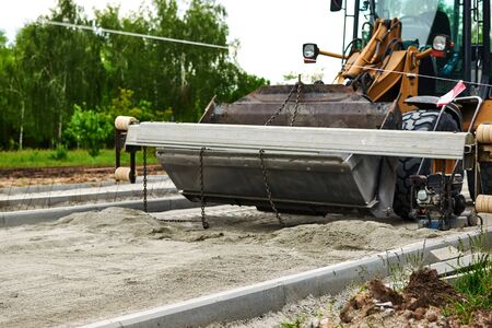 Men at work. The construction roller makes the road. Make a new road surface.の写真素材