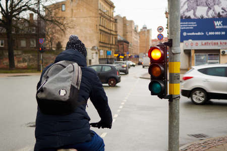 Riga, Latvia- February 07, 2020: Cyclist on the road in the city.のeditorial素材