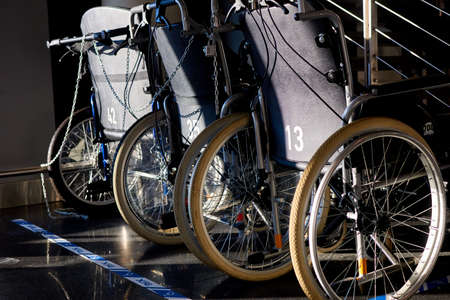Riga, Latvia- February 06, 2020: a row of wheelchairs at the airport premises.のeditorial素材