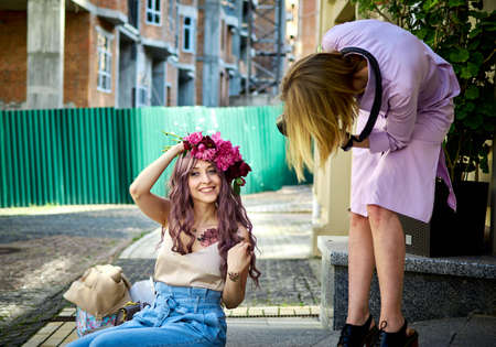 Kiev, Ukraine - June 07, 2020: A woman photographer takes pictures of a girl in the streetのeditorial素材