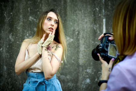 Kiev, Ukraine - June 07, 2020: A woman photographer takes pictures of a girl in the streetのeditorial素材