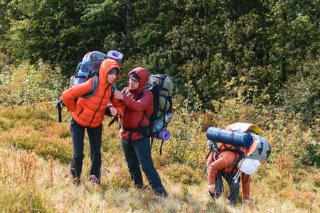 Carpathians, Ukraine- September 29, 2018: A group of people hiking on a halt during a tourist hike.