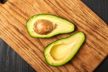 Sliced avocado on a wooden background.の写真素材