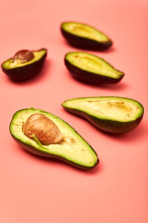 Sliced avocado on a pink background.の写真素材