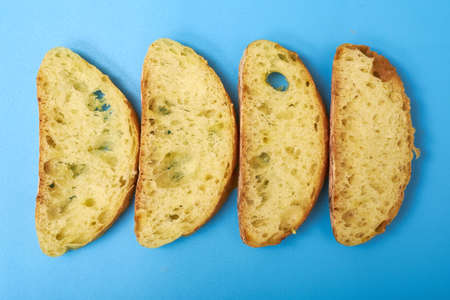 Sliced ciabatta on a blue background.