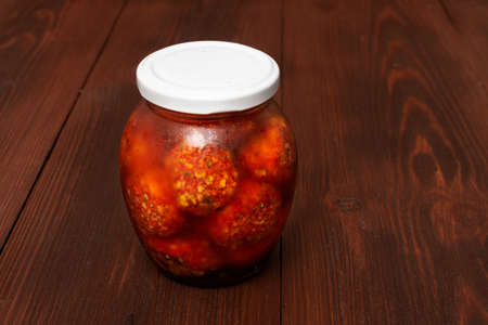 Mix of vegetables canned in a jar on a wooden background.の写真素材