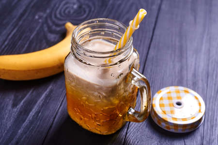 Fresh banana smoothie on a wooden background. Proper healthy eating.の写真素材