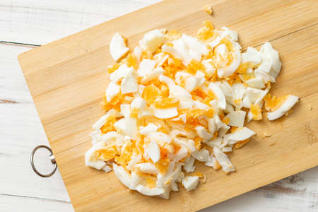 chopped chicken eggs on a cutting board. Ingredient for cooking