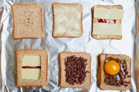Making sandwiches from toast bread with minced meat, egg and cheese. Different stages of the...
