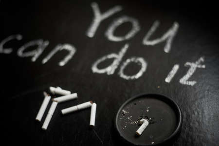 Quit smoking. You can do it- inscription on a black background.の写真素材