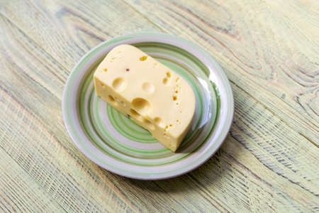 A piece of Dutch cheese on a plate.の写真素材