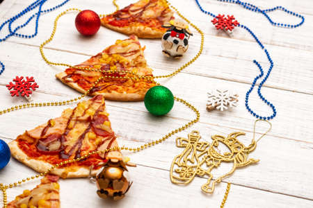 Christmas tree made of pizza on a white wooden background.の写真素材