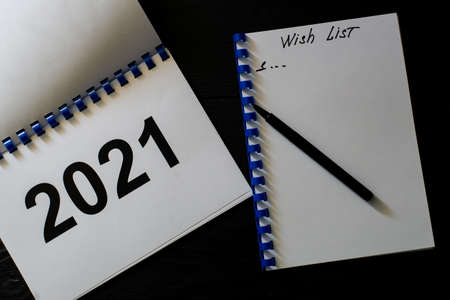 Wishlist for 2021 on a black wooden background.