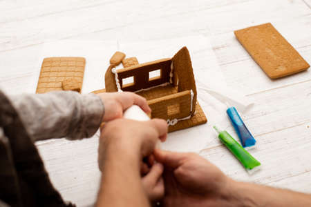 Dad and son are making a gingerbread house. Preparing for Christmas.の写真素材