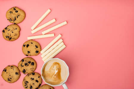 Cookies with chocolate and sweet rolls on a pink background. Sweet background.の写真素材