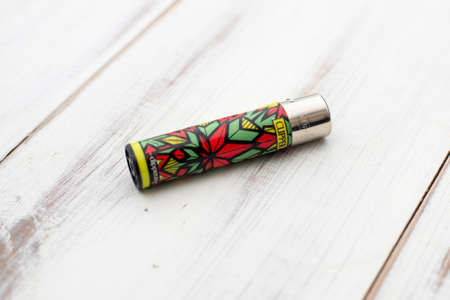 Kiev, Ukraine - November 28, 2021: Clipper lighter on a white wooden background.