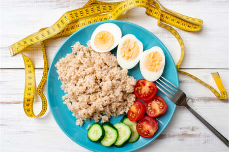 Diet and centimeter. Porridge on the water, chicken eggs. Healthy, proper nutrition.の写真素材