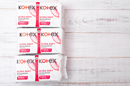 Kiev, Ukraine, -13 December, 2020: Packages with Kotex sanitary pads on a white wooden background....