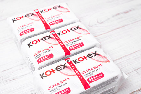Kiev, Ukraine, -13 December, 2020: Packages with Kotex sanitary pads on a white wooden background. Feminine hygiene product.のeditorial素材