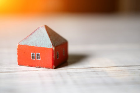 Wooden toy house on a light background. Real estate, construction, rental housing concept.の写真素材