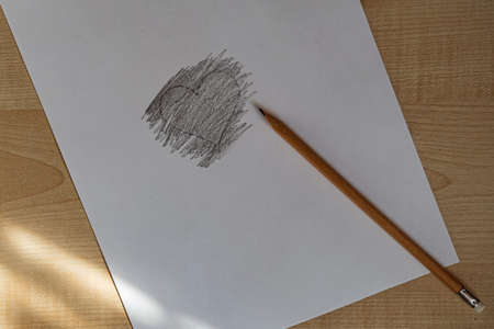 Heart drawn in black pencil on paper.