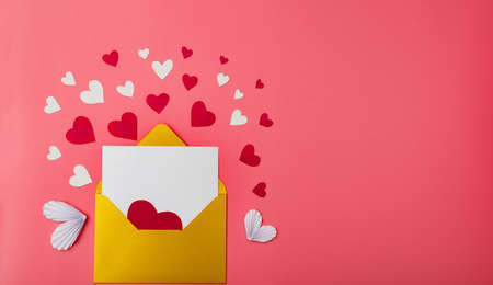 Gold envelope and hearts on a red background. Love letter for valentine's day concept. Place for your text. Banner.の写真素材