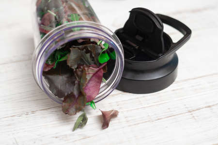 Mix of different lettuce leaves on a wooden background. Vegetarian food.の写真素材