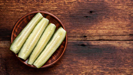 chopped pickled cucumbers on a dark wooden background. Place for your text.の写真素材