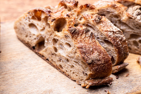 Pieces of buckwheat bread. Sliced baguette on a wooden board.