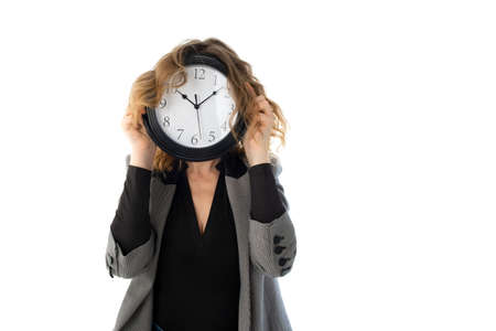 A woman holds a watch in front of her face. Isolated on white. Deadline, procrastination conceptの写真素材