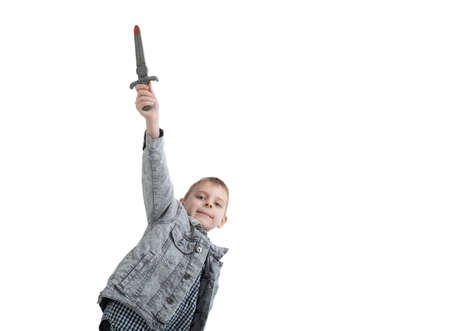 Young boy holding a toy dagger isolated on a white background.の写真素材