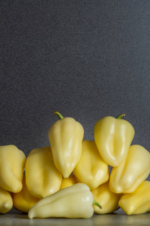 Fresh yellow peppers heap on the kitchen table. Preparation for cooking.の写真素材